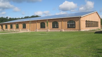 A large building with a long, flat roof and multiple arched windows.