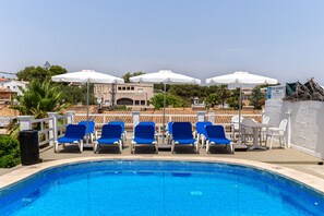 Seasonal outdoor pool, open 10:00 AM to 6:00 PM, pool umbrellas