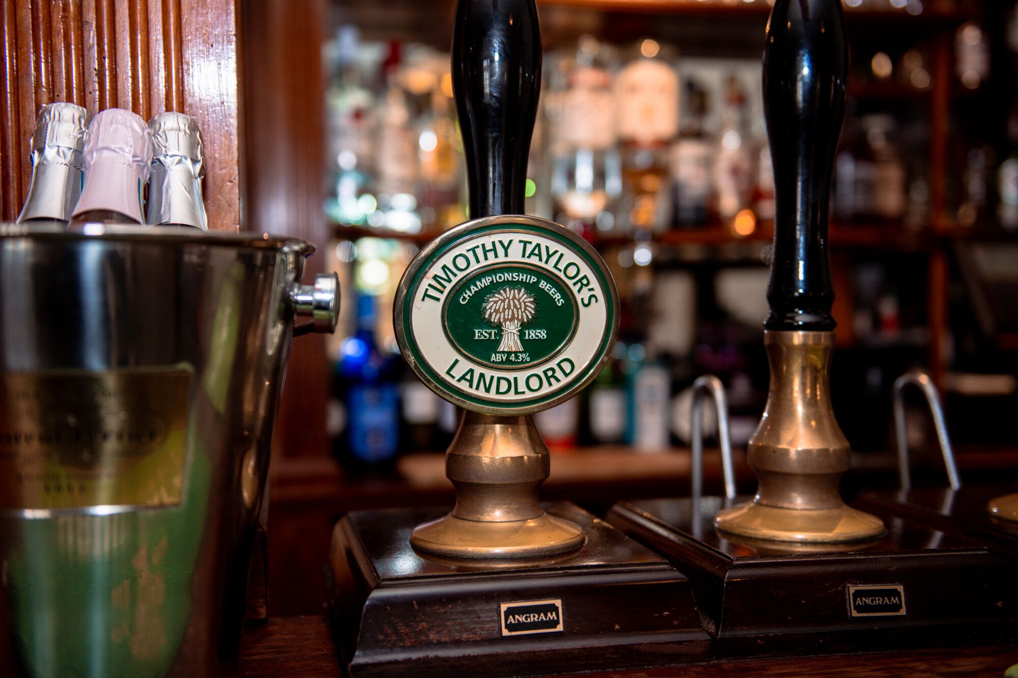 A tap labeled "Timothy Taylor's Champion Beers Landlord" with a brass handle and a green label.