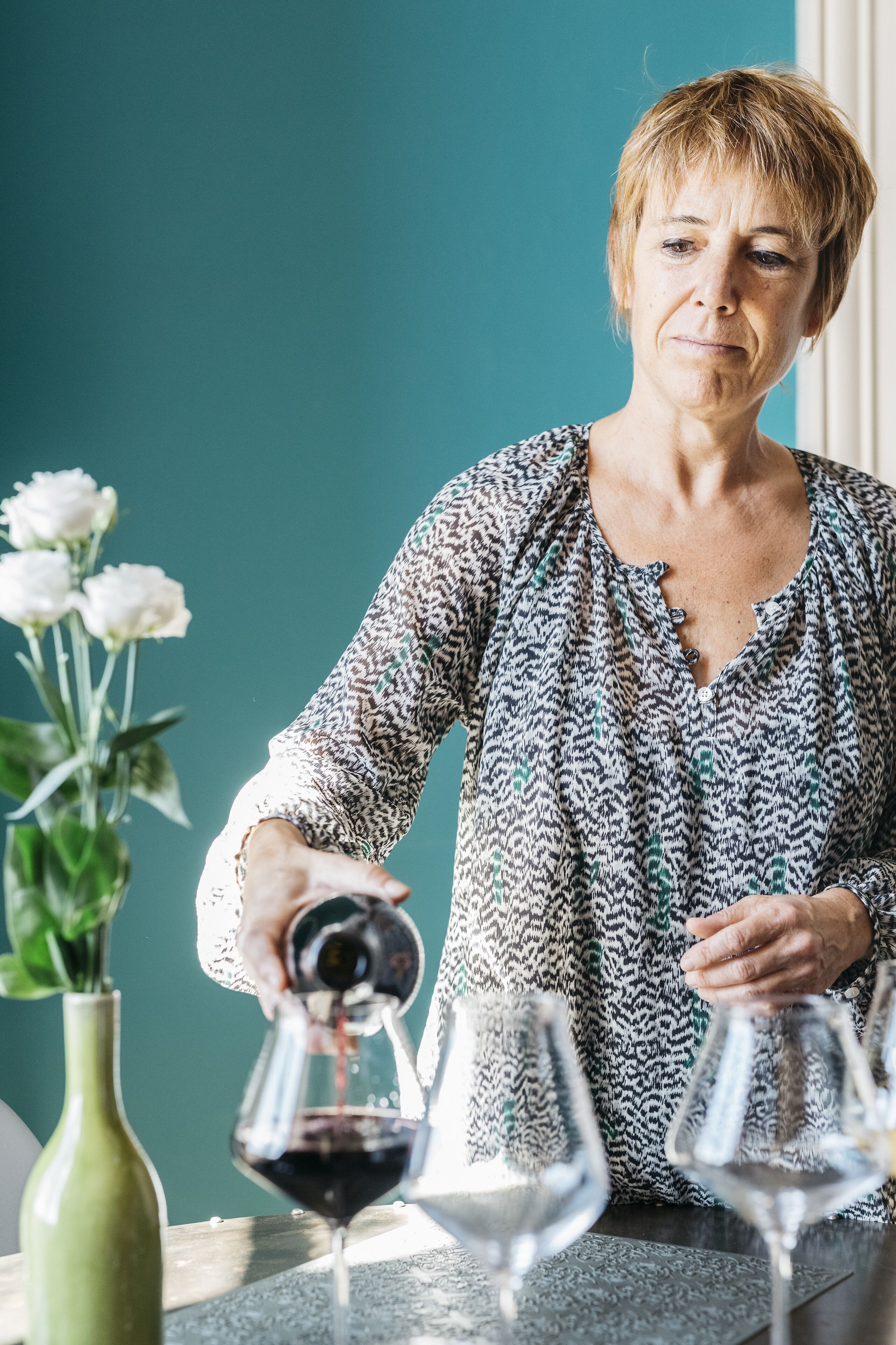 Una persona sirve vino en una copa.