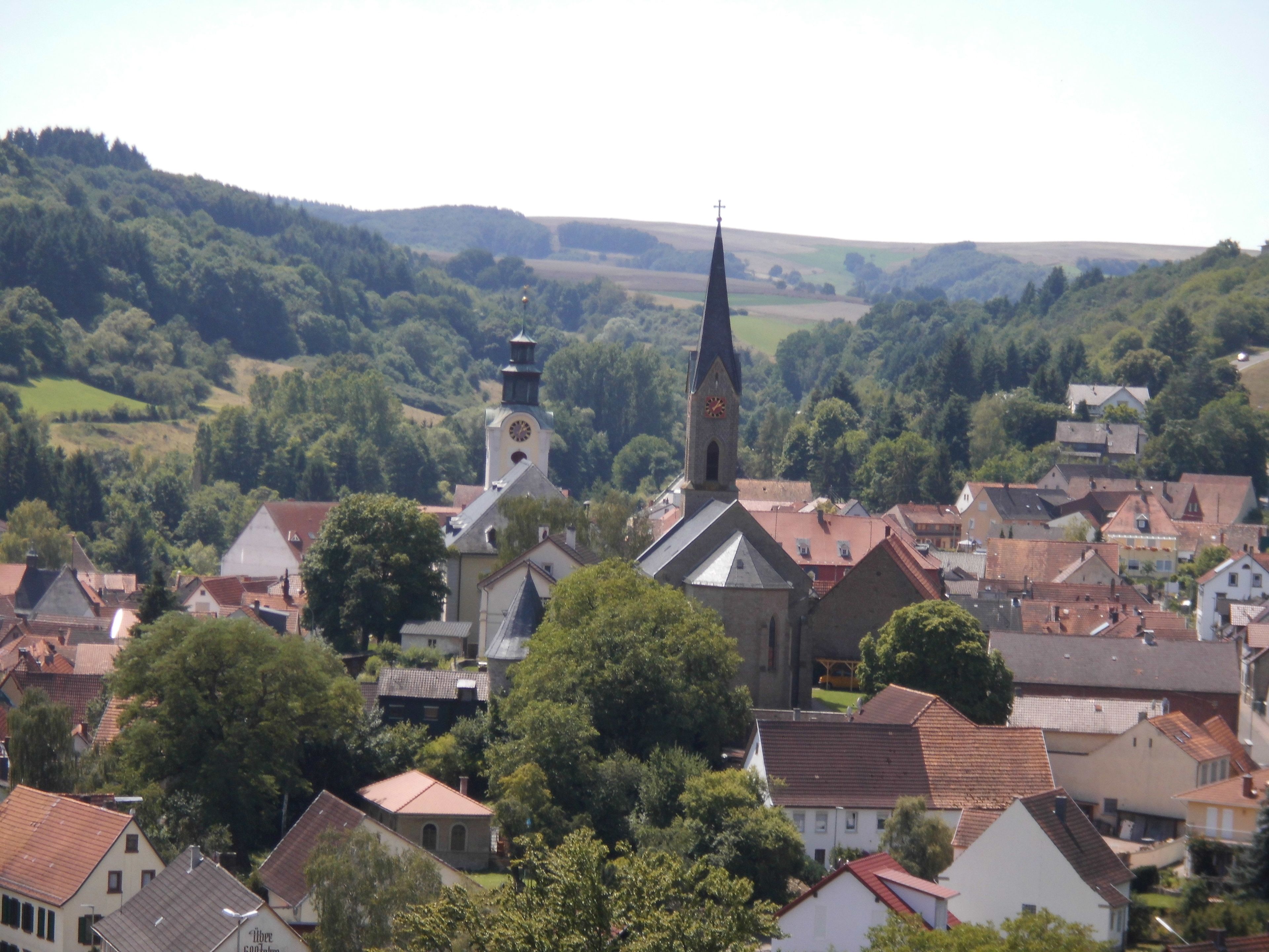 A town with a prominent church featuring a tall steeple and a clock tower.