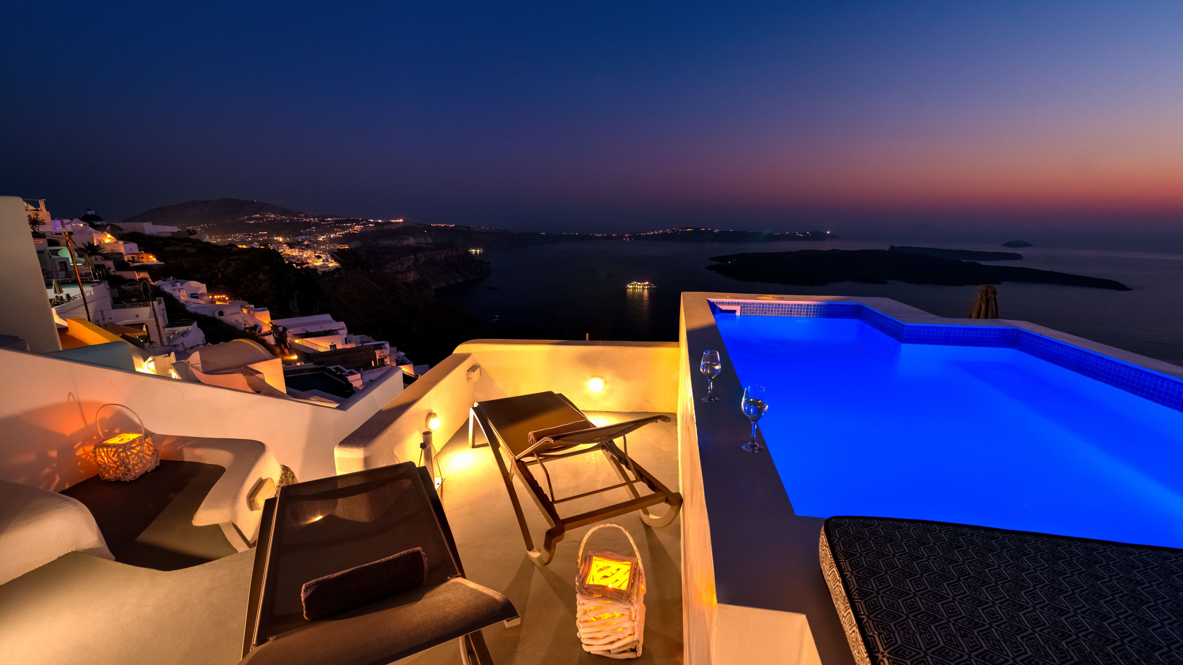 An infinity pool, a rooftop pool, pool umbrellas, pool loungers