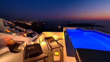 An infinity pool, a rooftop pool, pool umbrellas, pool loungers