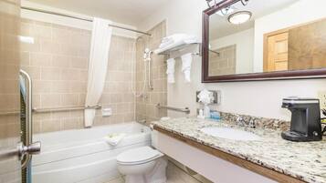 A bathroom with a bathtub, toilet, and sink.