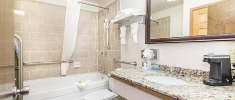 A bathroom with a bathtub, toilet, and sink.