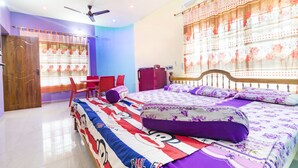 A bedroom with a bed, a desk, and a chair. There is a window with curtains and an air conditioning unit on the wall. - GuestHouser 3 BHK Cottage 26O3 (Vanur)