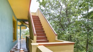 A staircase with a checkered floor leading to a balcony, surrounded by greenery. - GuestHouser 3 BHK Cottage 26O3 (Vanur)
