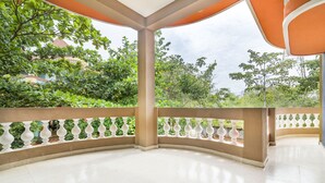 An empty, tiled outdoor area with a curved balcony, white balustrades, and orange awnings. - GuestHouser 3 BHK Cottage 26O3 (Vanur)