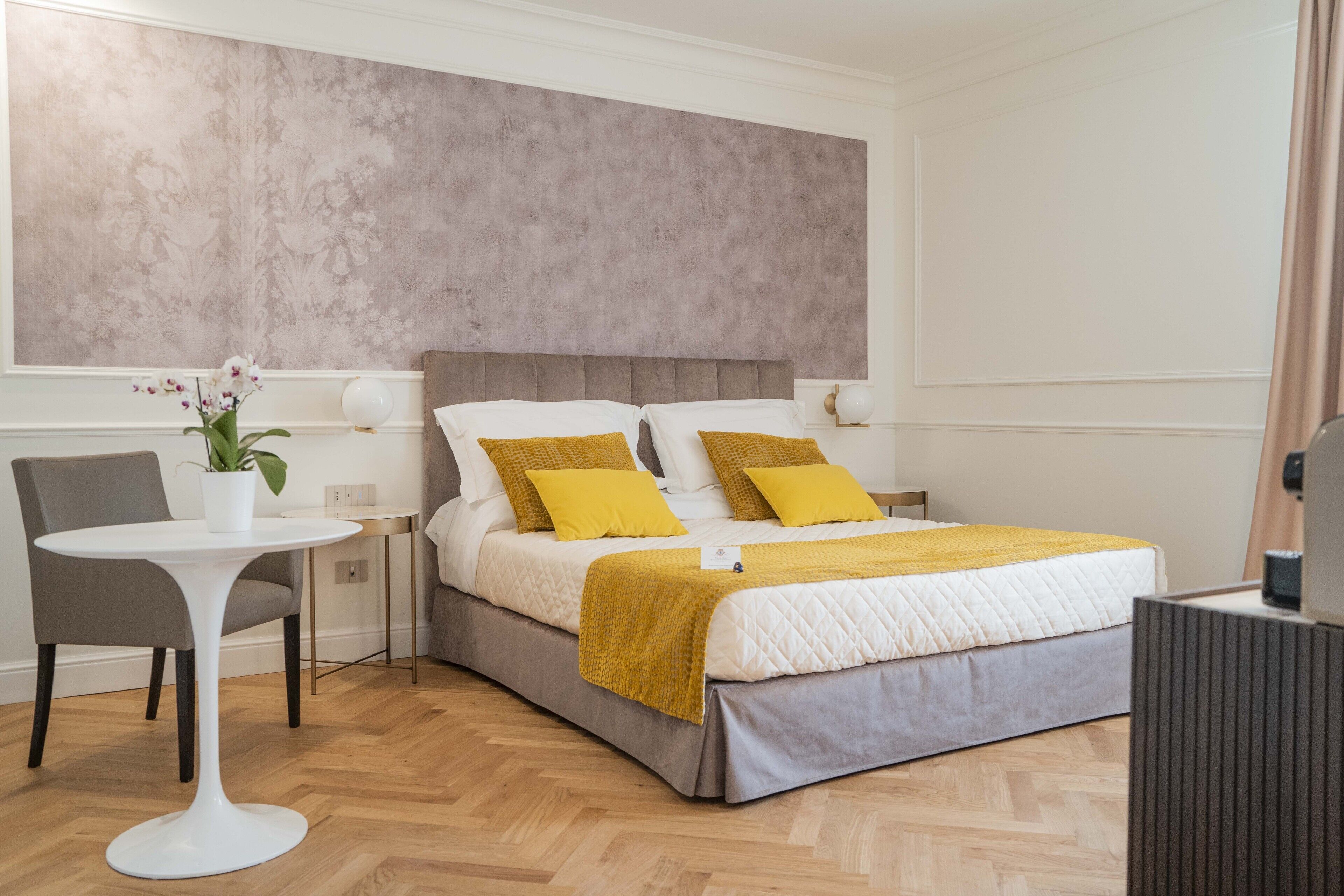 A modern bedroom with a bed, a small table, and a chair.