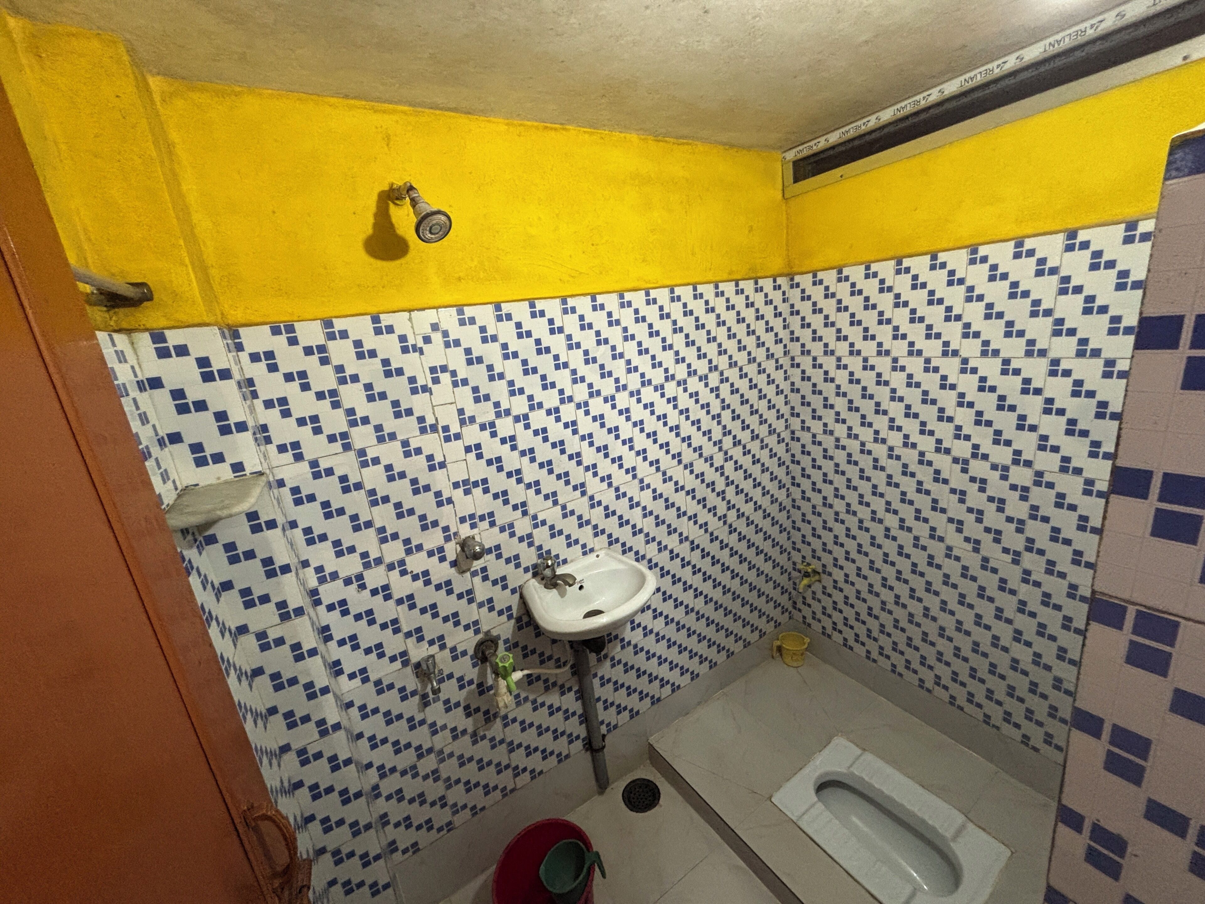 A small bathroom with a toilet, a sink, and a shower.