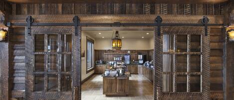 A rustic kitchen with wooden cabinetry and a central island.