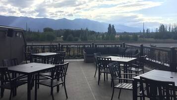 Enjoy an outdoor seating area with stunning mountain views, perfect for dining with friends or family.