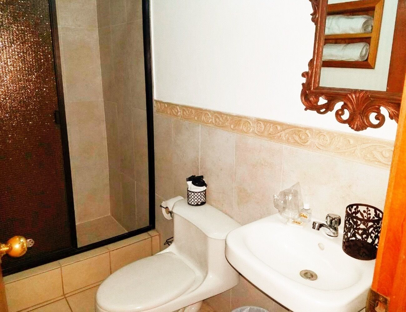 Un baño con inodoro, lavabo y ducha.