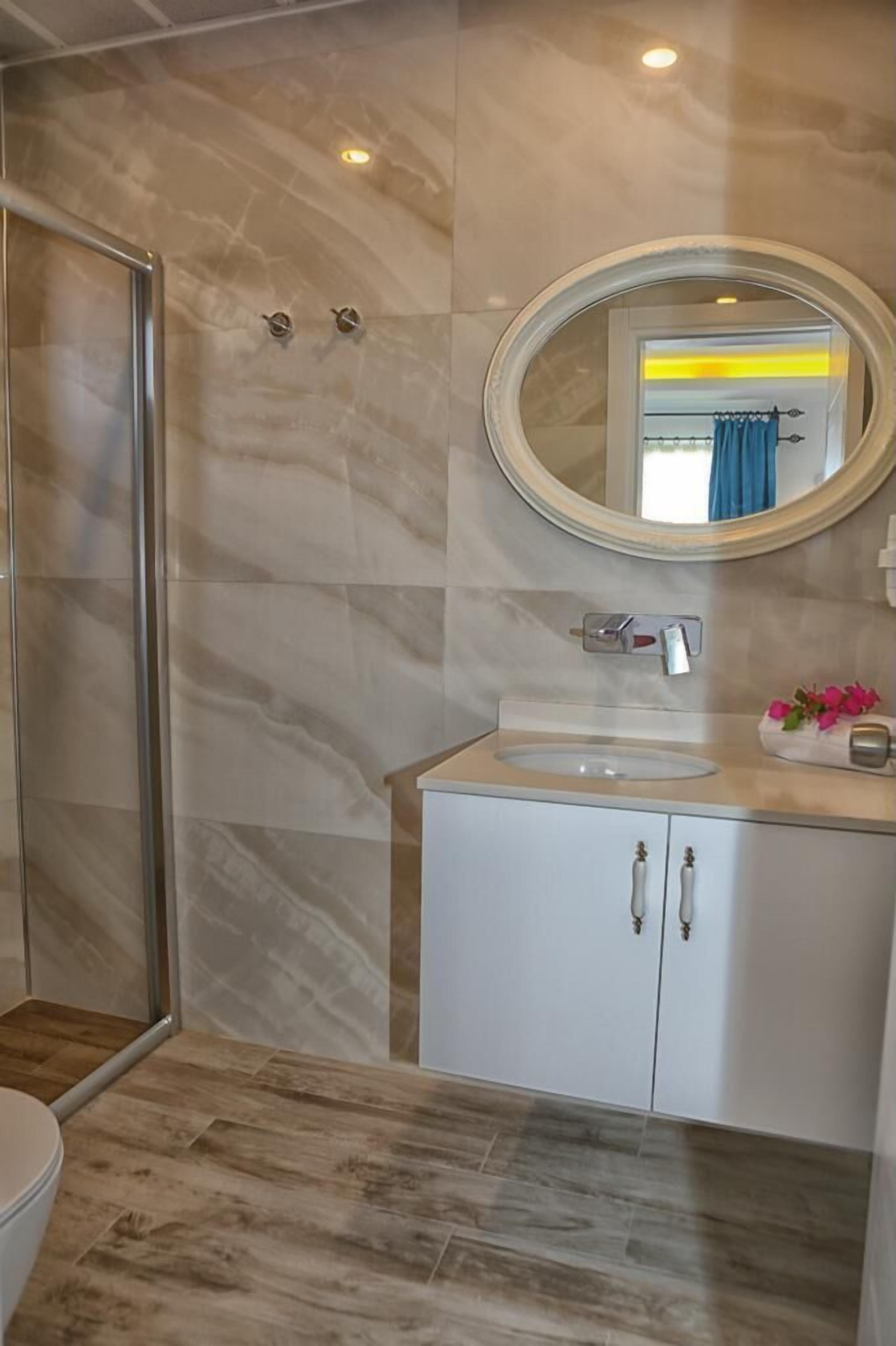 standard triple room | bathroom | shower, rainfall showerhead, hair dryer, slippers