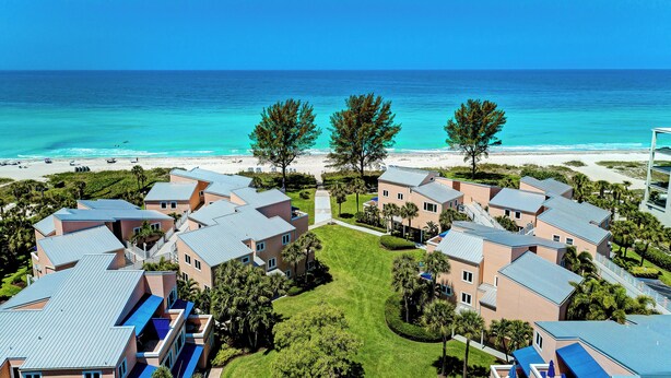 A resort with multiple buildings, a beach, and a clear view of the ocean. - Unit #305 Sand Cay Beach Resort Gulf View (Longboat Key)