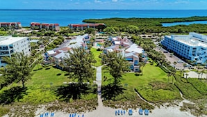 A resort with multiple buildings, a pool, and a view of the ocean. - Unit #215 Sand Cay Beach Resort Gulf View (Longboat Key)