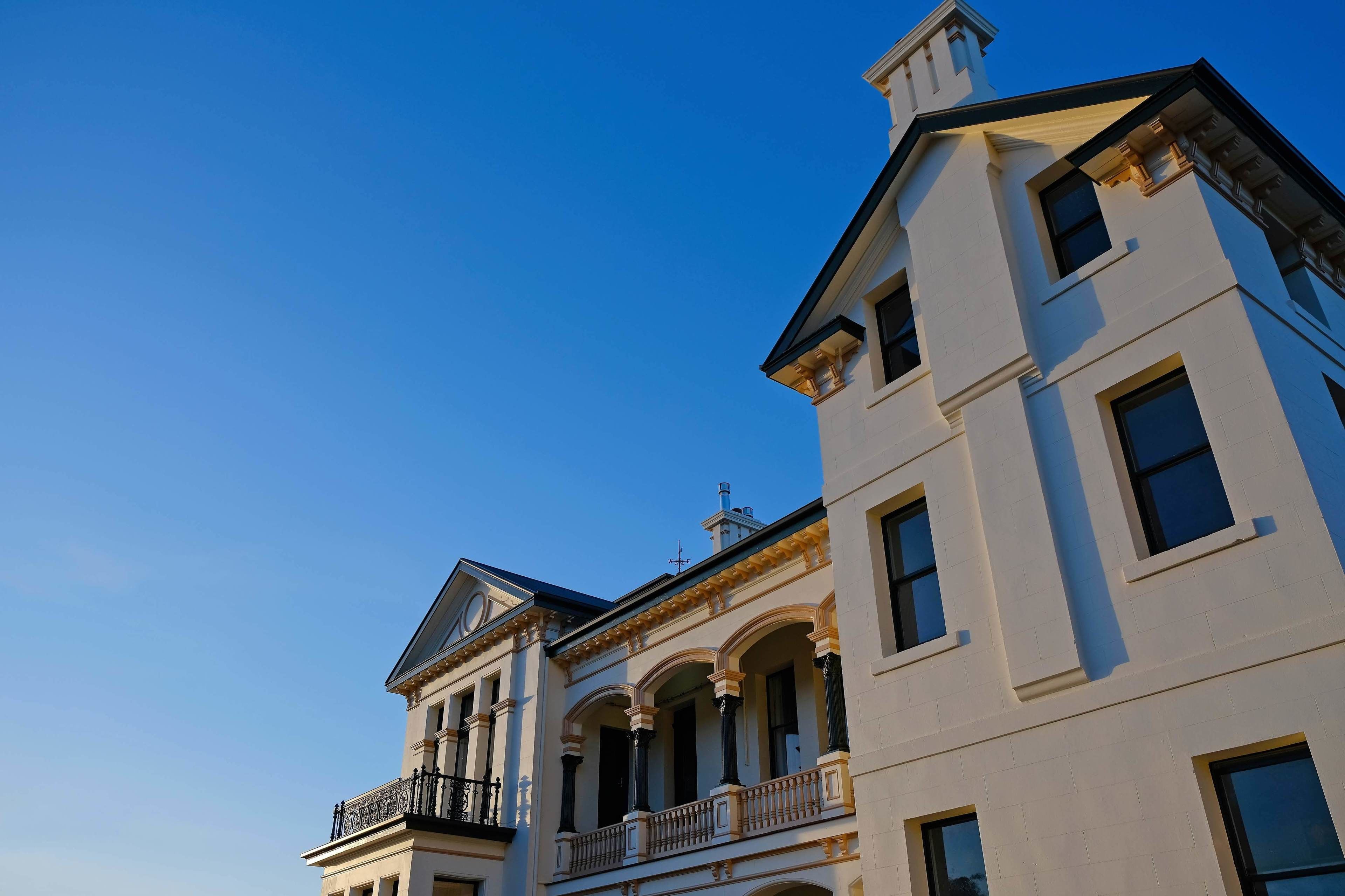 A multi-story building with a classical architectural style, featuring arched windows and balconies.