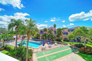 A hotel with a swimming pool, outdoor seating, and a shuffleboard court. - Unit #307 Sand Cay Beach Resort Pool View (Longboat Key)