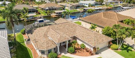A residential area with houses, a marina, and a river.