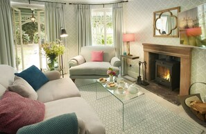 Ground floor: Unique sitting room with wood burning stove and glass doors opening into the garden