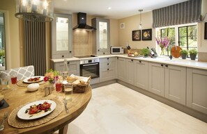 Ground floor: Spacious kitchen with dining table and chairs