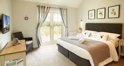 A delightful lodge with hot tub on Wakes Hall Farm is a haven of peace