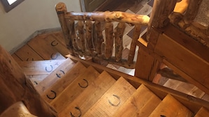 A wooden staircase with carved balusters and horsehair rings on the steps.