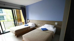 A hotel room with two beds, a balcony, and a view of the outdoors. - Phumi Resort (Thep Krasattri)