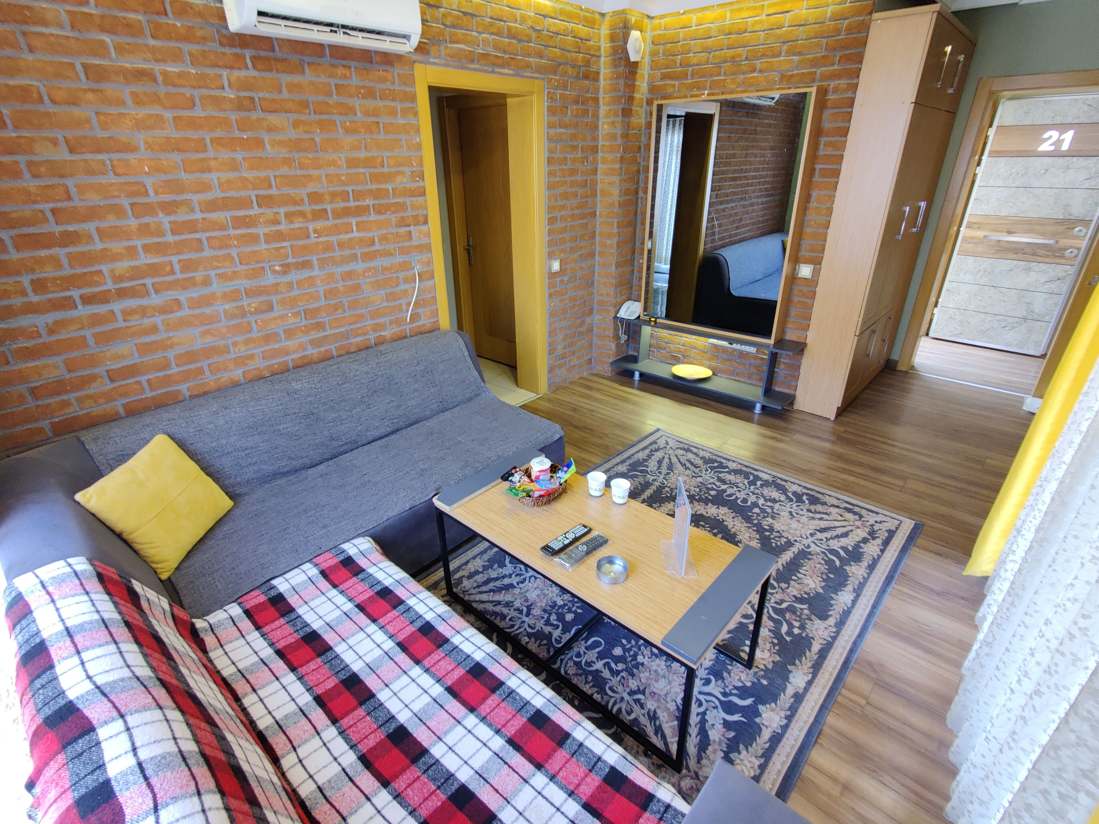 A compact living space with a sofa, a coffee table, and a patterned rug.