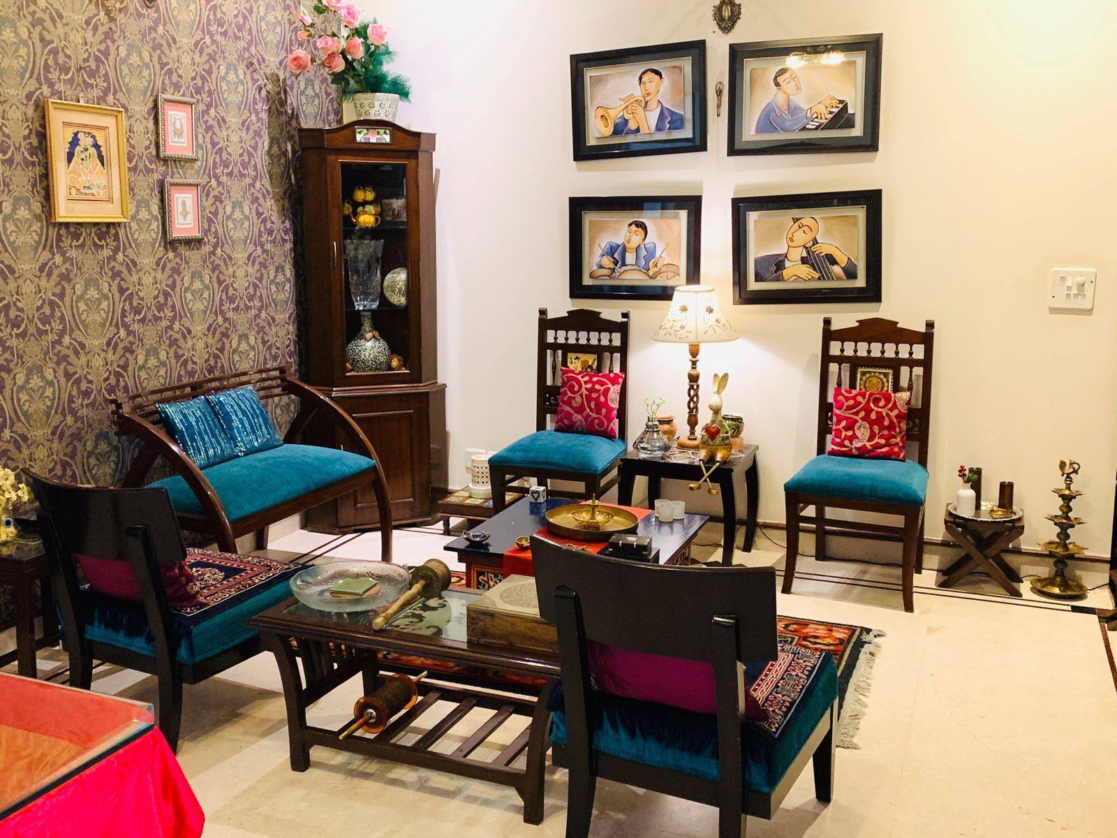A traditional living room with a sofa, chairs, a coffee table, and a cabinet.