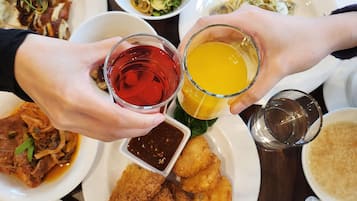 A variety of dishes including sushi, fried items, and a plate with bread and eggs.