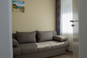 Suíte família | Área de estar | TV de tela plana