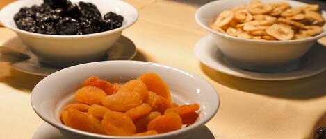Three bowls of food on a table.
