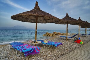 On the beach, sun loungers, beach umbrellas