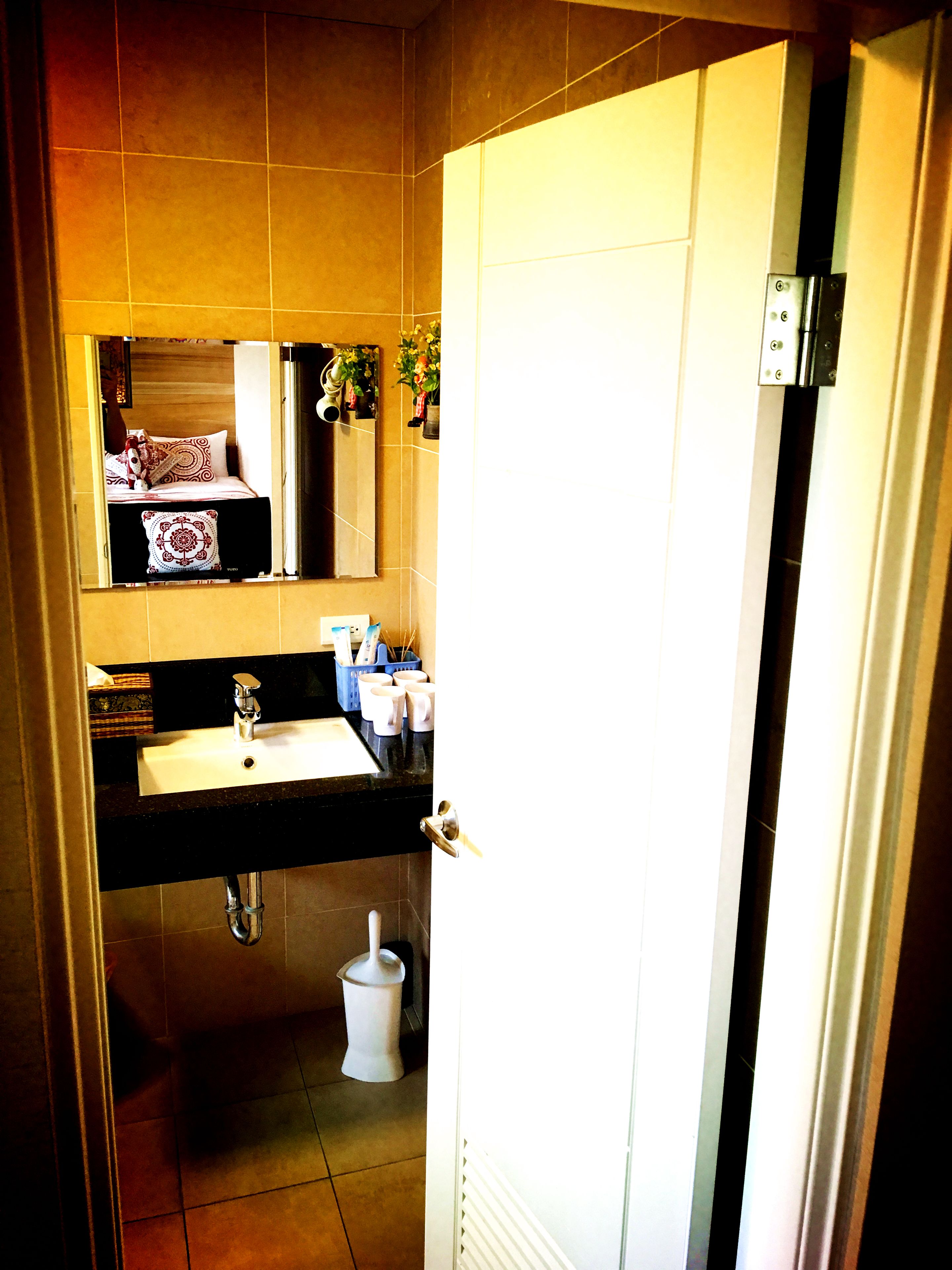 A bathroom with a sink, mirror, and toilet.