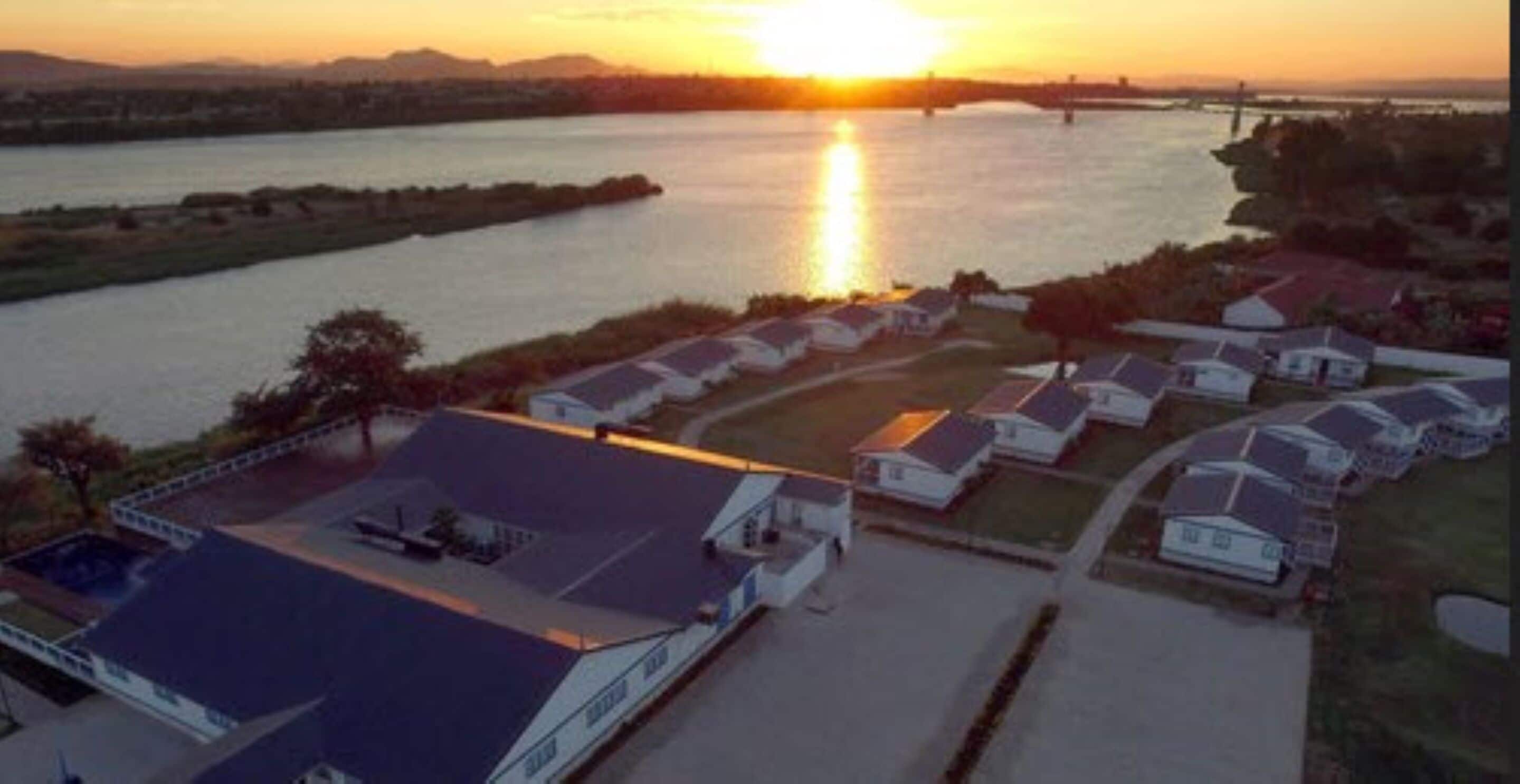 A residential area with houses and a large body of water.