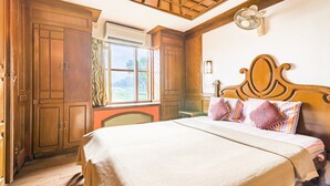 A bedroom with a wooden headboard, a bed with a striped blanket, and a window with curtains. - GuestHouser 3 BHK Houseboat e567 (Kuttanad Taluk)
