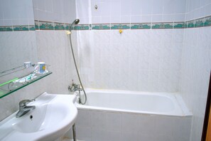 Combined shower/tub, free toiletries, hair dryer, slippers
