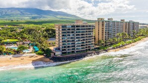 A beachfront hotel with multiple high-rise buildings, a pool area, and a beach.