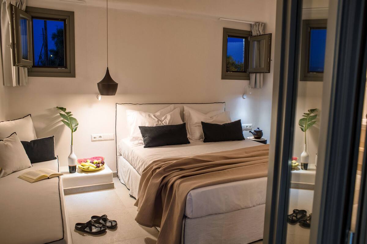 A bedroom with a bed, bedside table, and a nightstand.