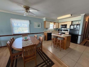 Enjoy meals in the kitchen with a central island and oven, or dine at the round table with comfortable chairs.
