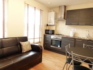 Apartment, 1 Bedroom | Living area | Flat-screen TV, DVD player