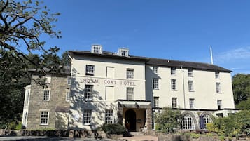 A two-story building with the sign 'ROYAL COAT HOTEL' on the facade.