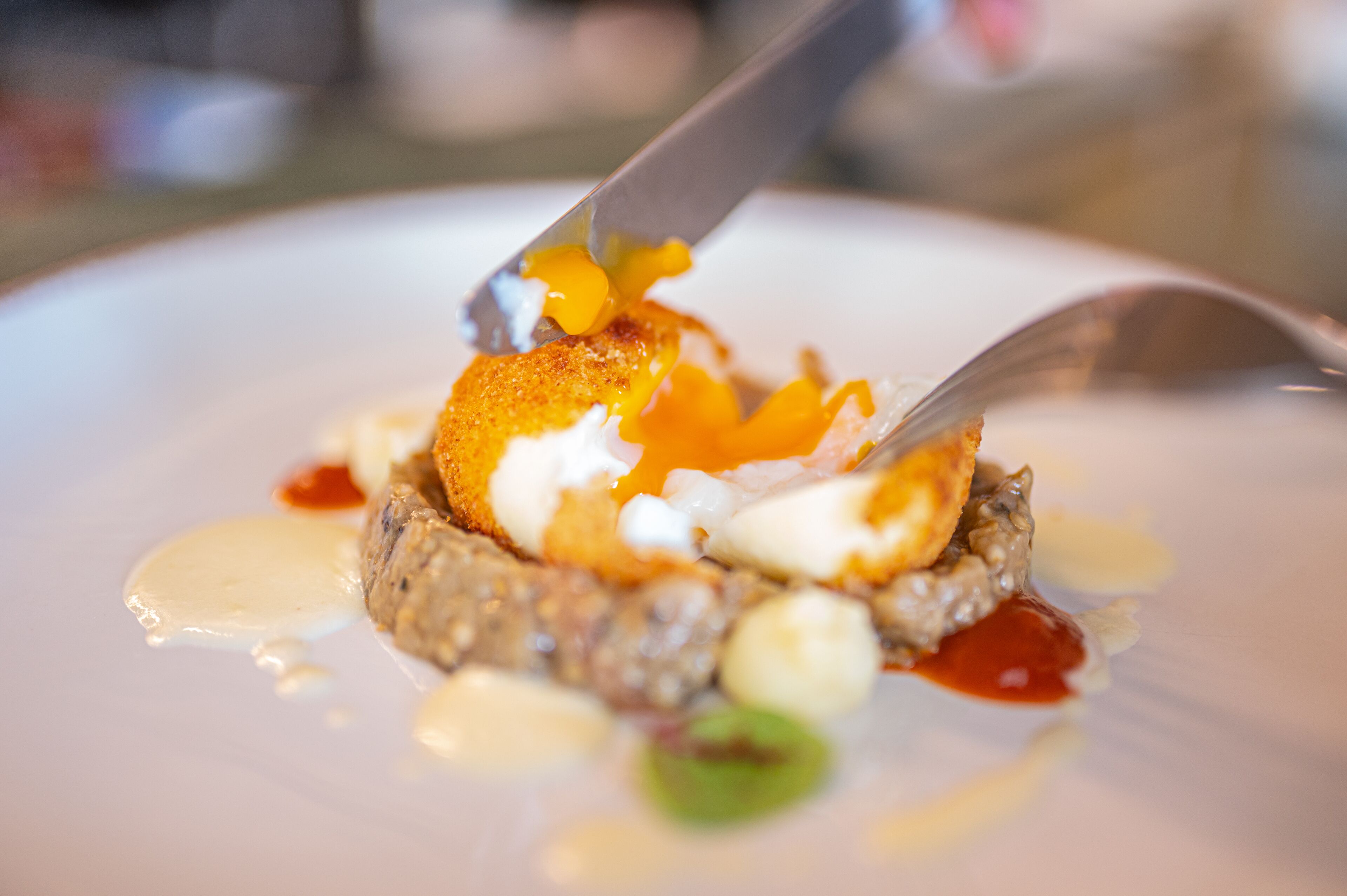 A dessert with a caramelized topping and a dollop of cream on a plate.
