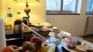 A breakfast table with various food items, a water bottle, a milk carton, and a lamp. - Les Voisins de l'Illet (Ercé-près-Liffré)