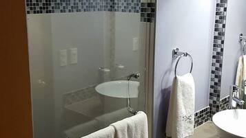 Suite, 1 King Bed | Bathroom | Shower, rainfall showerhead, free toiletries, towels