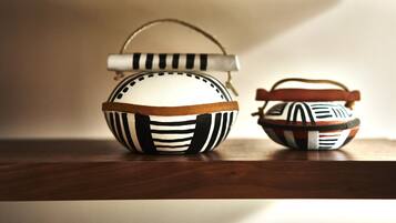Two decorative bowls with handles on a wooden surface.
