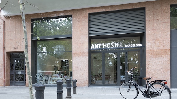 A hostel with a modern facade, large windows, and a bicycle parked outside. - ANT Hostel Barcelona (Barcelona)