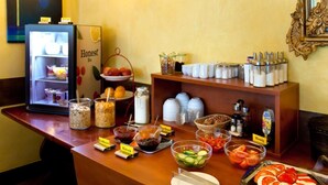 A buffet counter with various food items and condiments. - Hotel Weidenhof (Plettenberg)