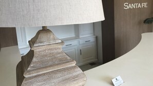 A lamp with a textured shade on a hotel reception desk. - Hotel Santa Fe (Santa Fe)
